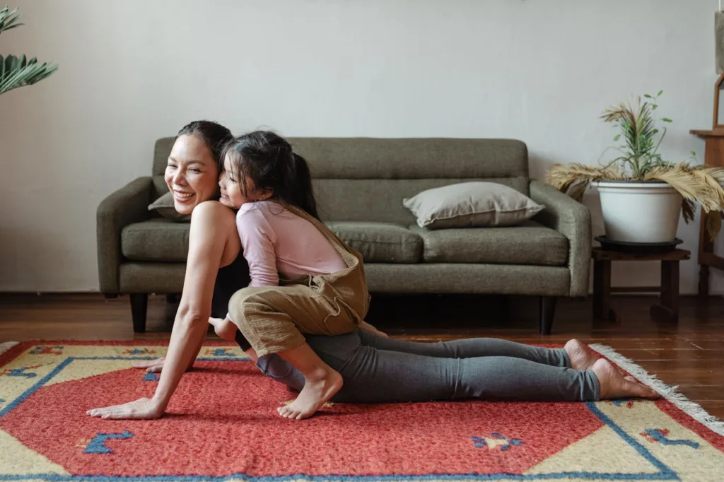 woman playing on the floor with her child